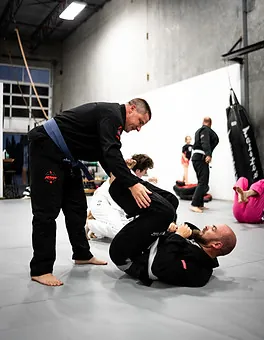 Coach guiding a student through a Brazilian Jiu Jitsu technique in Mission, BC